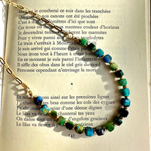 Load image into Gallery viewer, Blue tiger's eye necklace laid over an open book page - Let's Jam jewellery, Camden Market, London