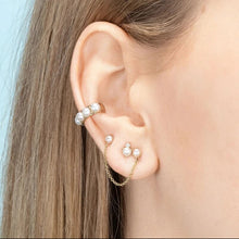Load image into Gallery viewer, Close-up of a woman's ear styled with a gold-plated pearl-studded ear cuff and double stud earrings with pearls connected by a fine chain - Let's Jam jewellery collection