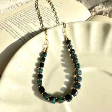 Load image into Gallery viewer, Black tiger's eye necklace draped over an open book - Let's Jam, Camden Market