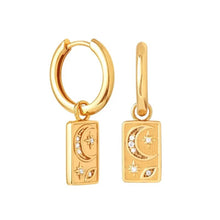 Load image into Gallery viewer, Pair of gold-plated earrings featuring a hoop and a drop style, each with a rectangular charm engraved with a crescent moon and stars set with zirconia stones, on a white background - Let's Jam jewellery collection