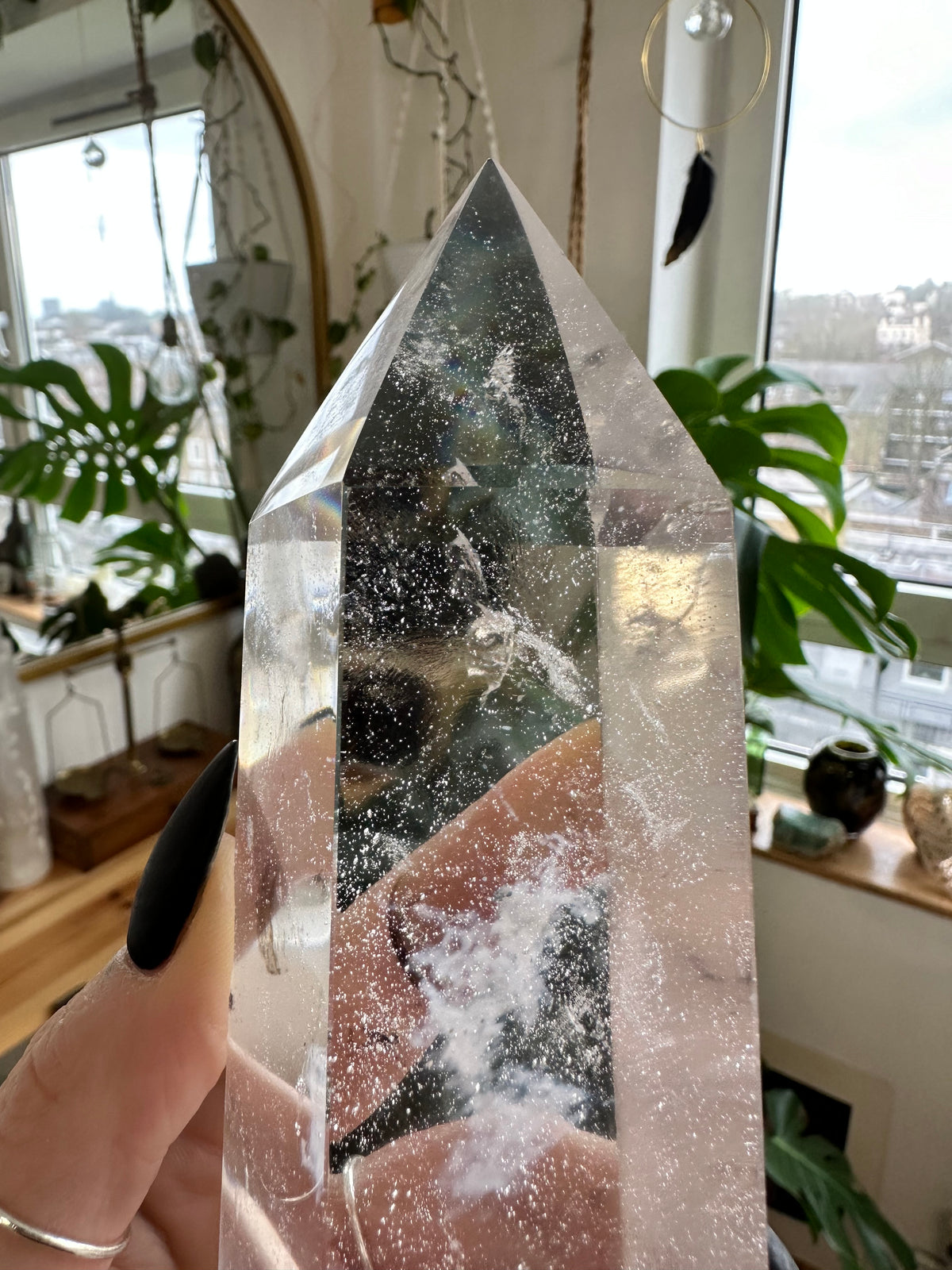 Quartz tower held up to the light, rainbows showing in the fractures - Let's Jam, Camden Market, London