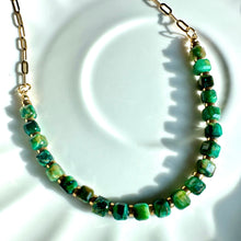 Load image into Gallery viewer, Green tiger's eye necklace coiled on a white plate beside a book - Let's Jam jewellery, Camden Market London