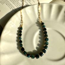 Load image into Gallery viewer, Black tiger's eye strand shown next to the gold chain for contrast - Let's Jam, Camden Market London