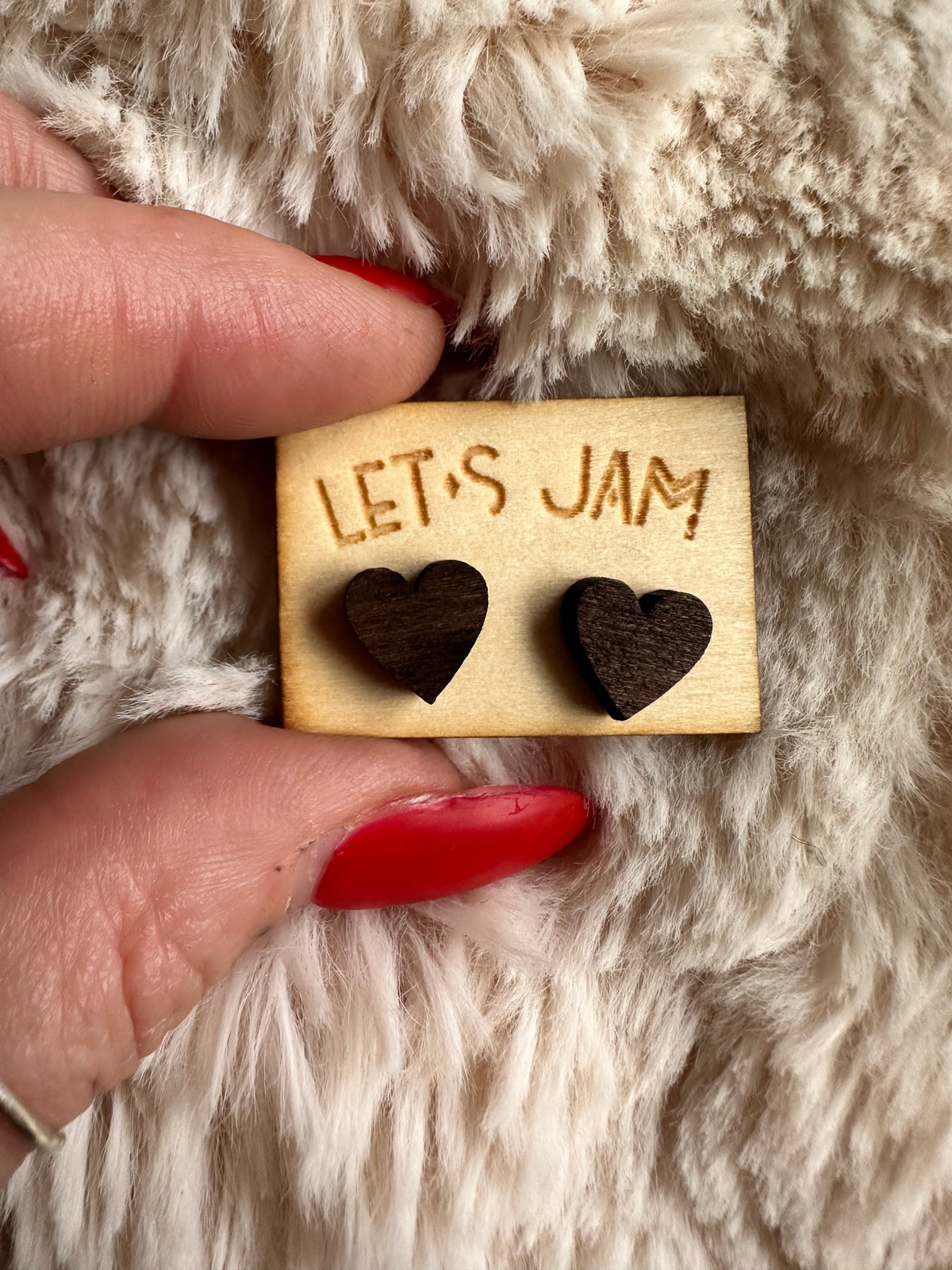 Close view of the little wooden heart studs and their grain - Let's Jam jewellery, Camden Market