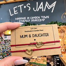 Load image into Gallery viewer, Two burgundy red cord bracelets with hollow heart charms on a Let's Jam "Mum & Daughter" card - Let's Jam, Camden Market, London