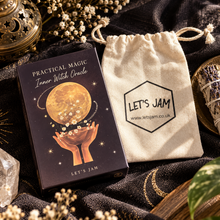 Load image into Gallery viewer, Inner Witch Oracle card deck box by Let's Jam next to its beige drawstring bag, styled with crystals, dried flowers, and a sage bundle on a dark patterned fabric background.