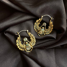Load image into Gallery viewer, Pair of handcrafted brass hoop earrings shaped like winged scarab beetles with blue abalone shell inlay, displayed on dark satin fabric - Let's Jam jewellery collection