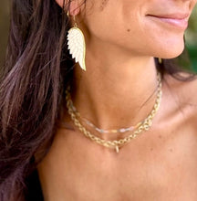 Load image into Gallery viewer, Close-up of the carved feather grooves in pale camel bone - Let's Jam jewellery, Camden Town London