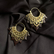Load image into Gallery viewer, Pair of ornate gold-tone hoop earrings with an intricately carved dark wood lotus flower petal fringe, displayed on dark satin fabric - Let's Jam jewellery collection
