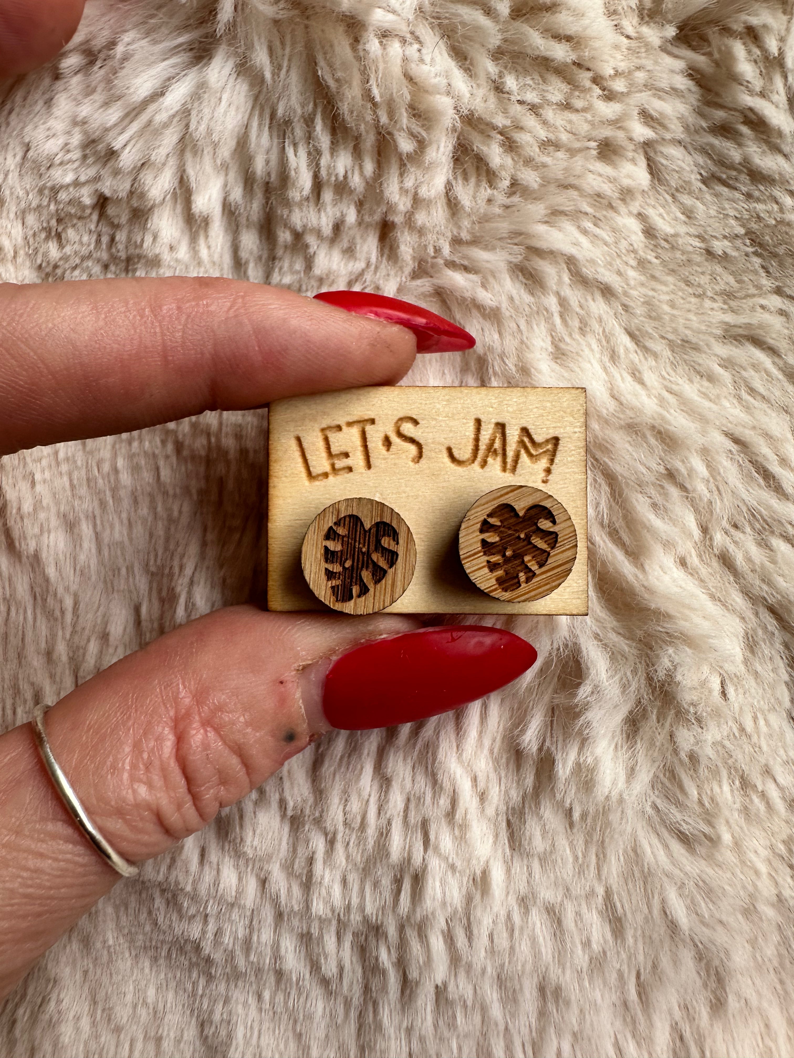 Close-up of the monstera leaf engraving in warm light wood grain - Let's Jam jewellery, Camden Town