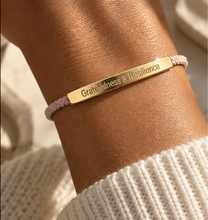 Load image into Gallery viewer, Pink cord bracelet with a gold Gratitude and Resilience bar and a knit sleeve - Let's Jam, Camden Town