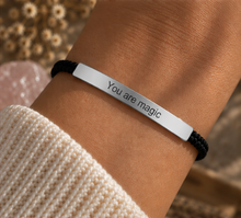 Load image into Gallery viewer, Black cord bracelet with a silver You Are Magic bar worn on the wrist - Let's Jam jewellery, Camden Market, London