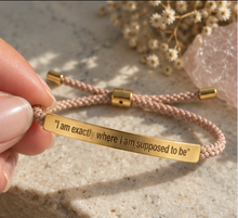 Load image into Gallery viewer, Blush pink cord bracelet with a gold engraved plate on a stone surface - Let's Jam, Camden Market London