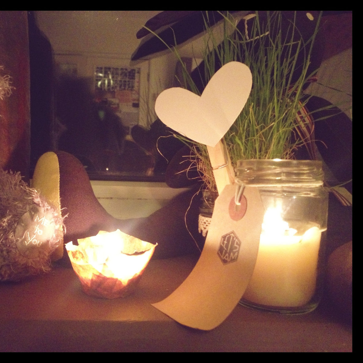 Let's Jam's very first handmade candle in a recycled jam jar with a brown gift tag and paper heart, 2014