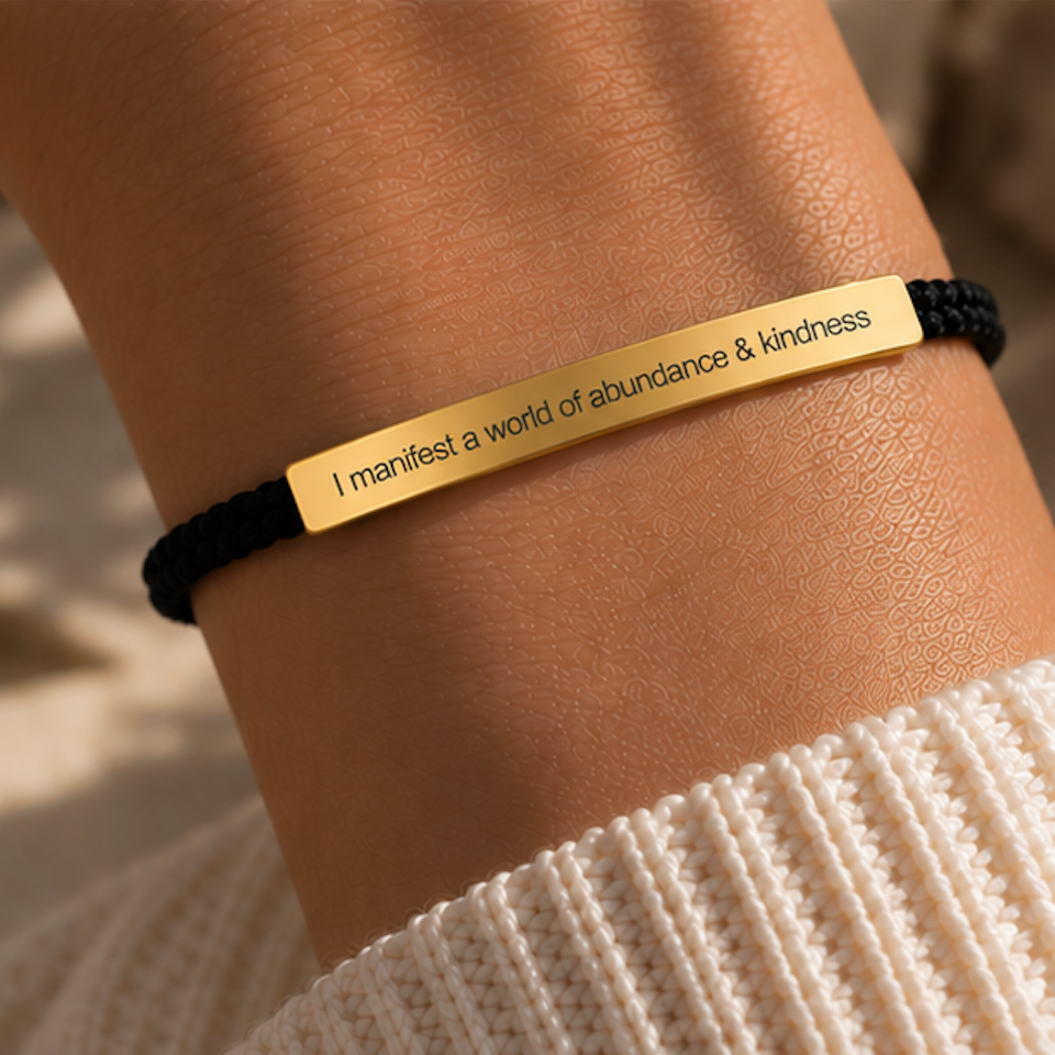 Black cord bracelet with a gold engraved plate fastened on a wrist - Let's Jam, Camden Town