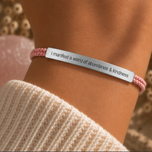 Load image into Gallery viewer, Pink braided bracelet with a silver engraved plate, worn with a knit jumper - Let's Jam, Camden Town London