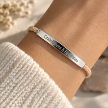 Load image into Gallery viewer, Pink cord bracelet with a silver Gratitude and Resilience bar, worn on the wrist - Let's Jam jewellery, Camden Market