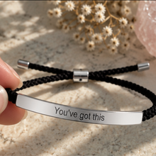 Load image into Gallery viewer, Hand holding a black cord bracelet with a silver You've Got This bar - Let's Jam, Camden Market London
