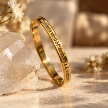Load image into Gallery viewer, Gold 'I manifest a world of abundance & kindness' ring leaning on a crystal - Let's Jam, Camden Market