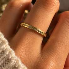 Load image into Gallery viewer, Hand wearing the gold 'I manifest a world of abundance & kindness' ring - Let's Jam jewellery, Camden Market