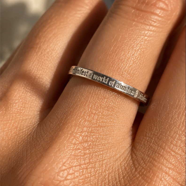 Hand wearing the silver 'I manifest a world of abundance & kindness' ring - Let's Jam jewellery, Camden Market