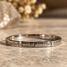 Load image into Gallery viewer, Silver affirmation ring engraved 'I manifest a world of abundance & kindness' - Let's Jam, Camden Market London
