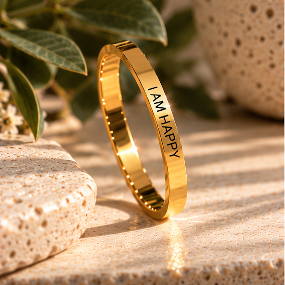 Gold 'I am happy' ring standing upright on a stone surface - Let's Jam, Camden Town London