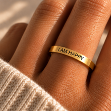 Load image into Gallery viewer, Hand wearing the slim gold 'I am happy' affirmation ring - Let's Jam jewellery, Camden Market London