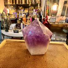Load image into Gallery viewer, Amethyst tower held in the hand to show its size and weight - Let's Jam, Camden Market, London