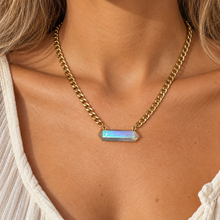 Load image into Gallery viewer, Aura quartz bar pendant on a gold Cuban chain being worn - Let's Jam, Camden Market, London