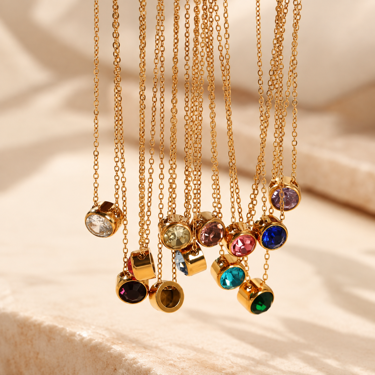 Gold birthstone necklaces in all 12 colours hanging together - Let's Jam, Camden Town London