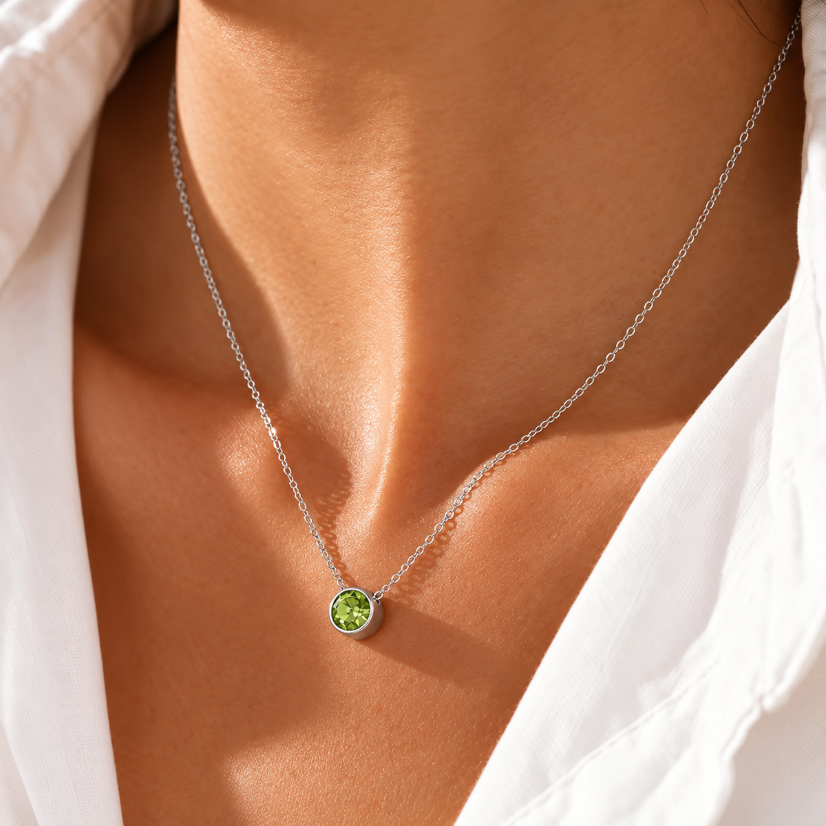 Silver birthstone necklace with a green August peridot stone, worn - Let's Jam, Camden Town London