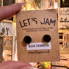 Load image into Gallery viewer, Round black tourmaline stud earrings in brass on their gift card - Let's Jam, Camden Town London