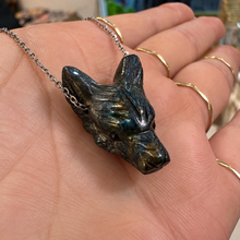 Load image into Gallery viewer, Dark carved wolf head pendant on a silver chain held in the hand - Let's Jam, Camden Market London