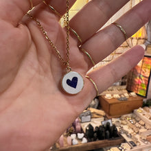 Load image into Gallery viewer, Round white ceramic pendant hand painted with a dark blue heart in the hand - Let's Jam, Camden Market, London