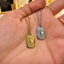 Load image into Gallery viewer, Gold and silver bright moon tag pendants held in the hand - Let's Jam, Camden Town London