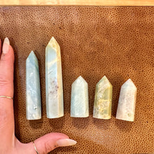 Load image into Gallery viewer, Caribbean blue calcite tower held in the hand to show its size - Let's Jam, Camden Town