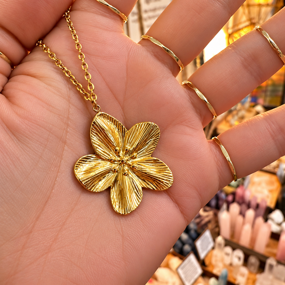 Gold cherry blossom flower pendant held in the hand - Let's Jam, Camden Town