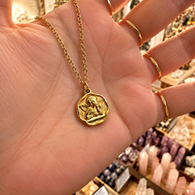 Load image into Gallery viewer, Gold cherub cupid medallion held in the hand - Let's Jam, Camden Market, London