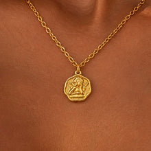 Load image into Gallery viewer, Close-up of a gold cupid medallion necklace worn - Let's Jam, Camden Town London