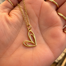 Load image into Gallery viewer, Gold open double heart pendant held in the hand - Let's Jam, Camden Market, London