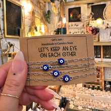Load image into Gallery viewer, Gold and silver evil eye matching bracelets on a Let's Keep An Eye On Each Other card - Let's Jam, Camden Town London