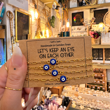 Load image into Gallery viewer, Gold evil eye matching bracelets on a Let's Keep An Eye On Each Other card - Let's Jam, Camden Town London