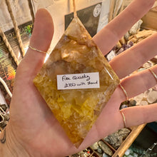 Load image into Gallery viewer, Fire quartz point on its stand photographed in the shop - Let's Jam, Camden Market