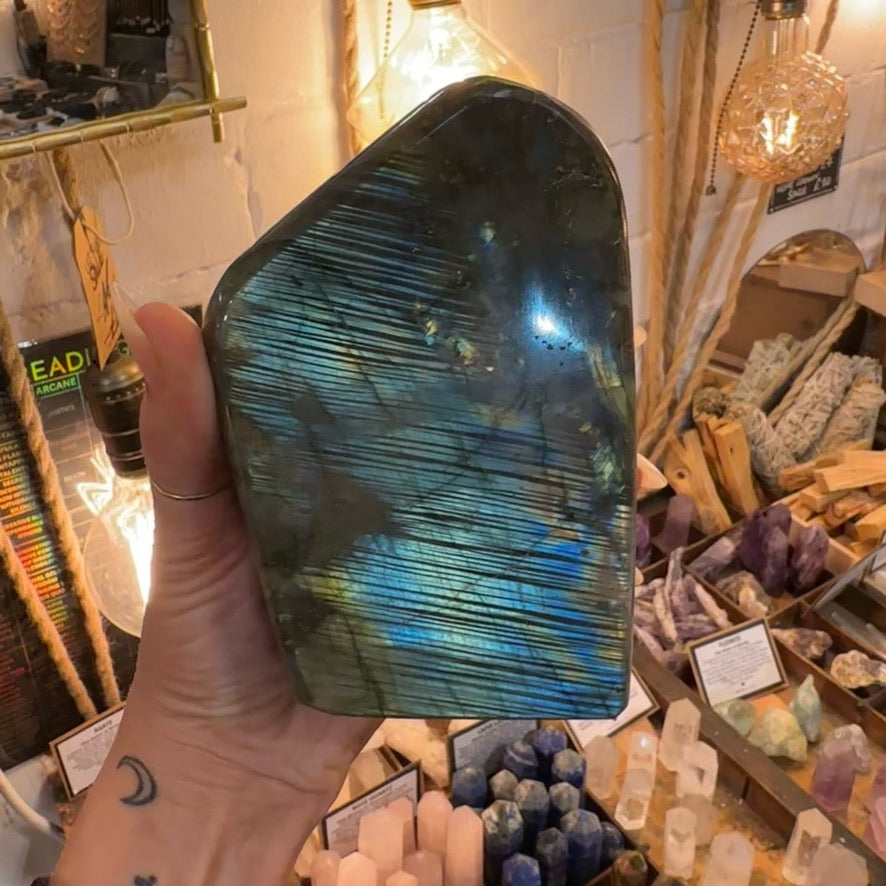 Large labradorite freeform filling one hand, showing its weight - Let's Jam, Camden Town London