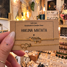 Load image into Gallery viewer, Two gold chain bracelets with elephant charms on a Let's Jam "Hakuna Matata" card - Let's Jam, Camden Market, London