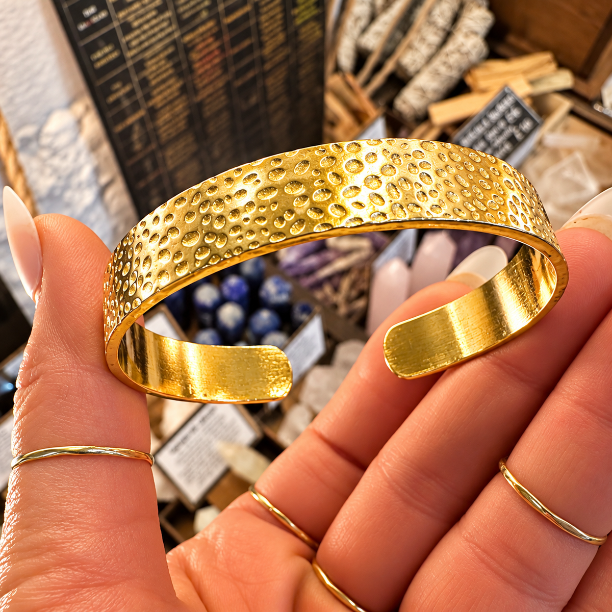 Hammered gold cuff bangle held in the hand - Let's Jam, Camden Town London