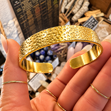 Load image into Gallery viewer, Hammered gold cuff bangle held in the hand - Let's Jam, Camden Town London