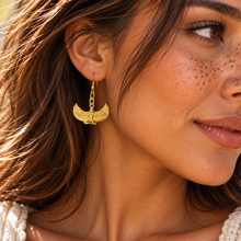 Load image into Gallery viewer, Gold winged goddess Isis drop earring being worn - Let's Jam, Camden Market London