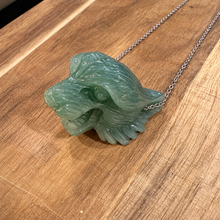 Load image into Gallery viewer, Hand carved jade tiger head on a silver chain laid on wood - Let's Jam, Camden Market